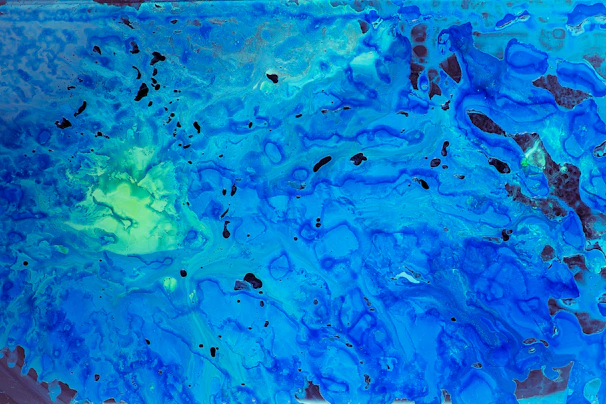 Abstract shapes in deep blue and lemon green dancing across a sea blue canvas, full of energy and flow.