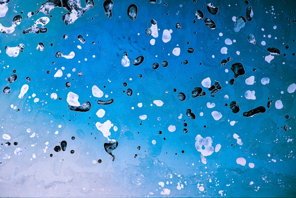 a close up of a blue and white wall with drops of water on it