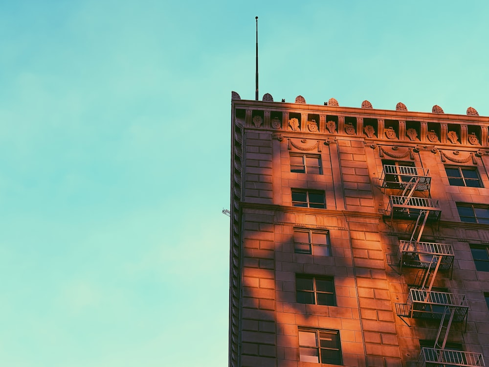 a tall building with a fire escape on top of it