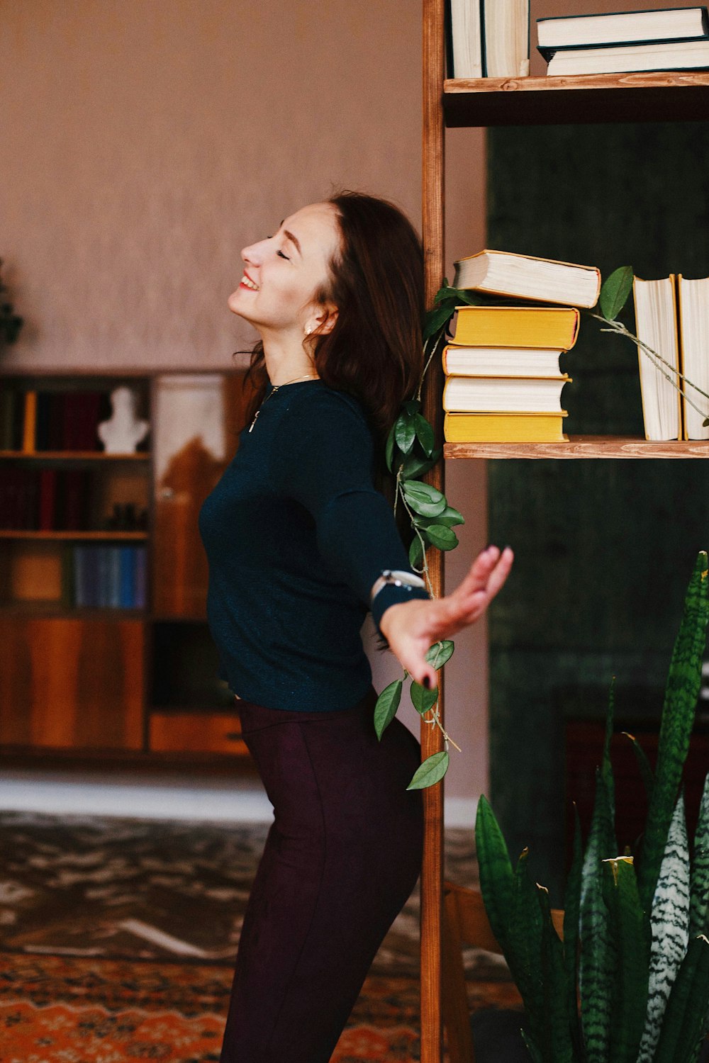 a woman standing in front of a book shelf