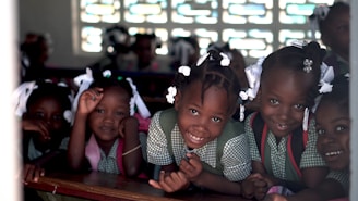 selective focus photo of children leaning on deks