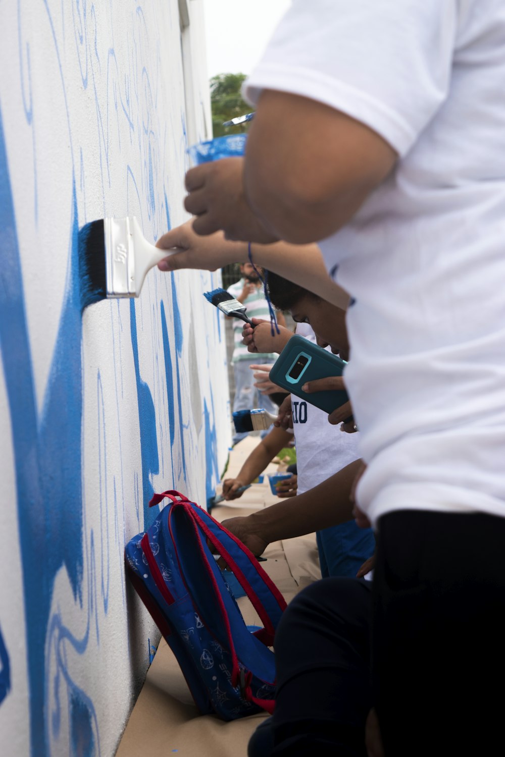 people painting on wall