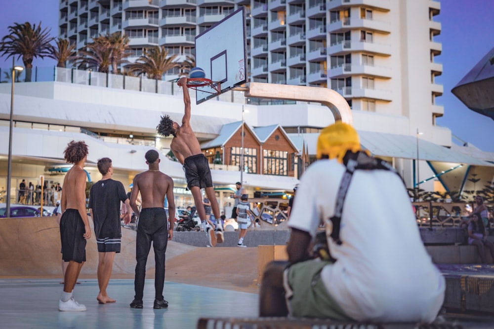 topless man dunking basketball