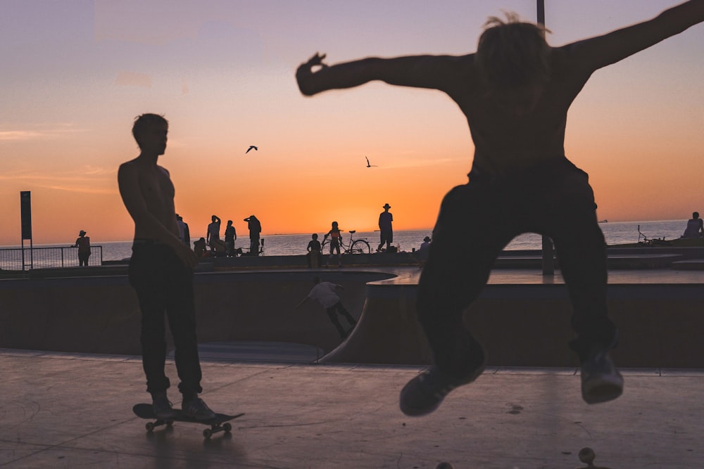 silhouette photography of skateboarders
