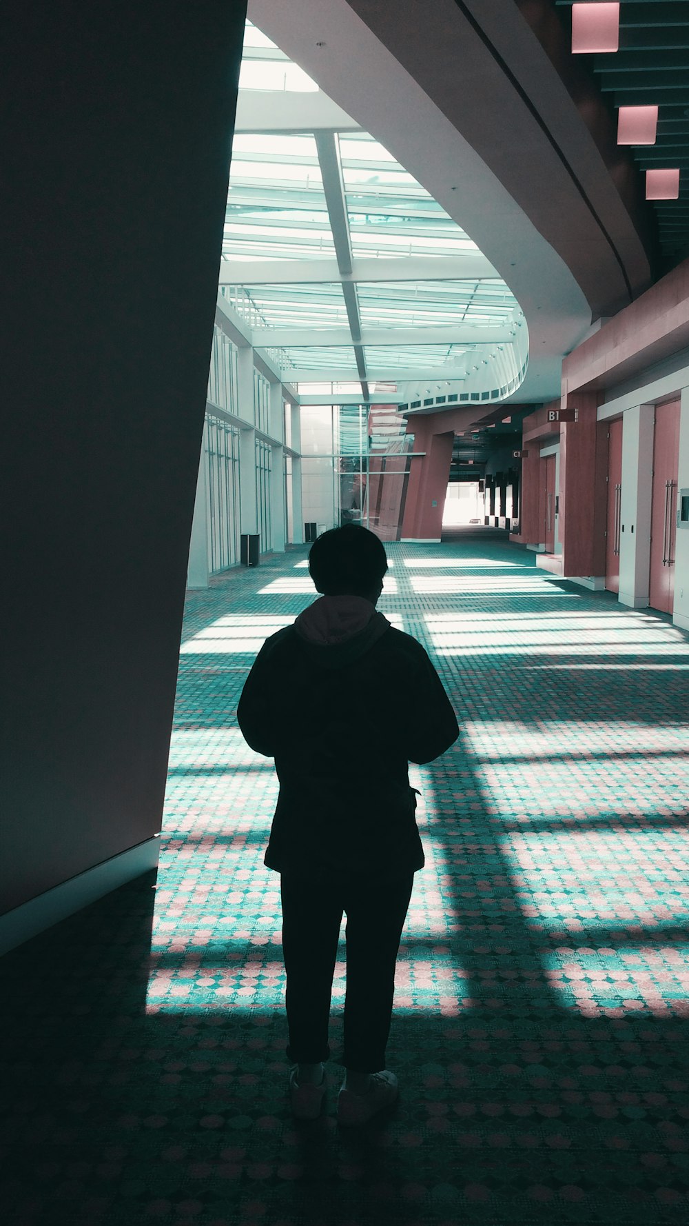 a person standing in a hallway in a building