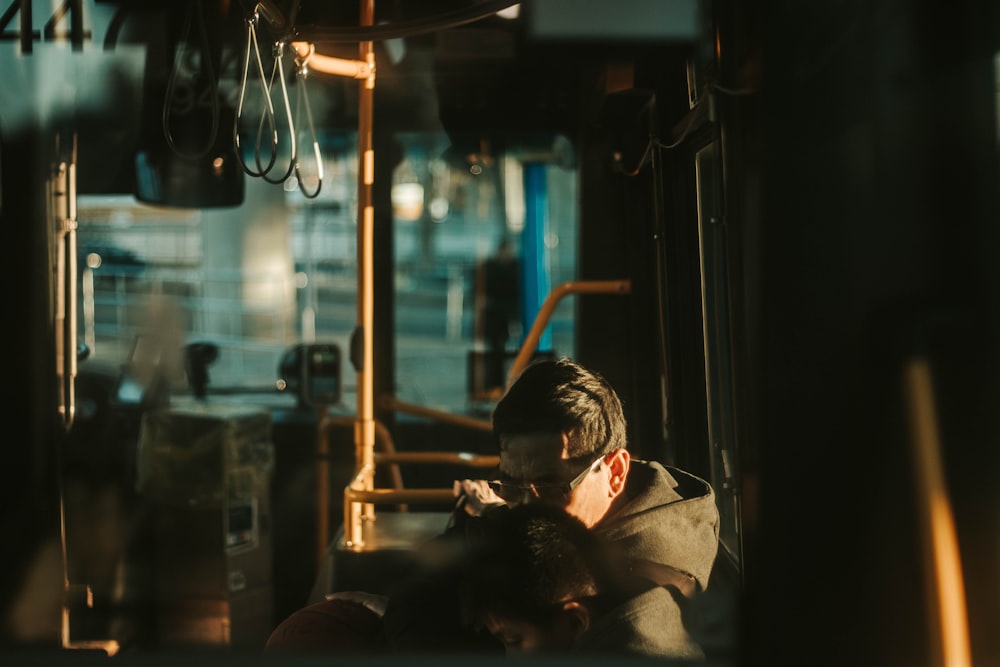 man sitting beside window