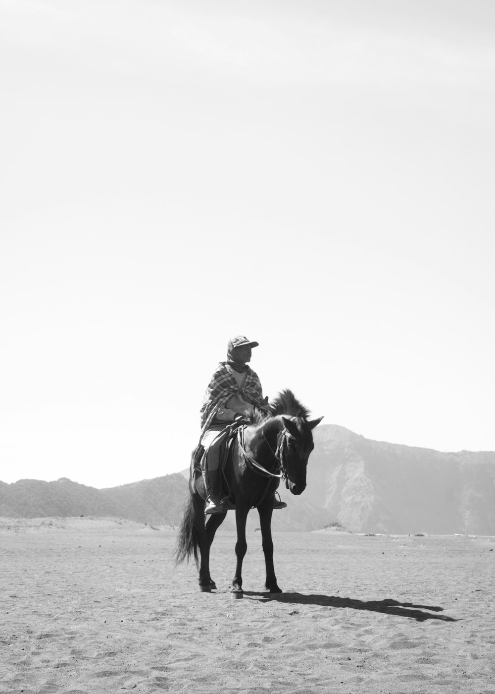 grayscale photography of man on horse