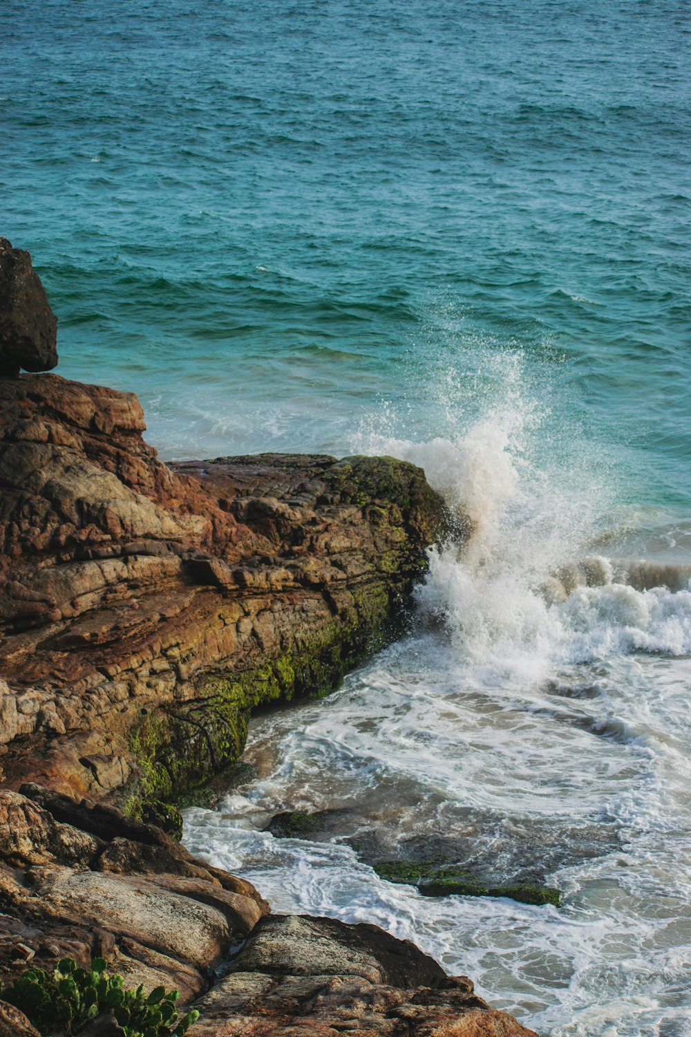 cliff beside body of water