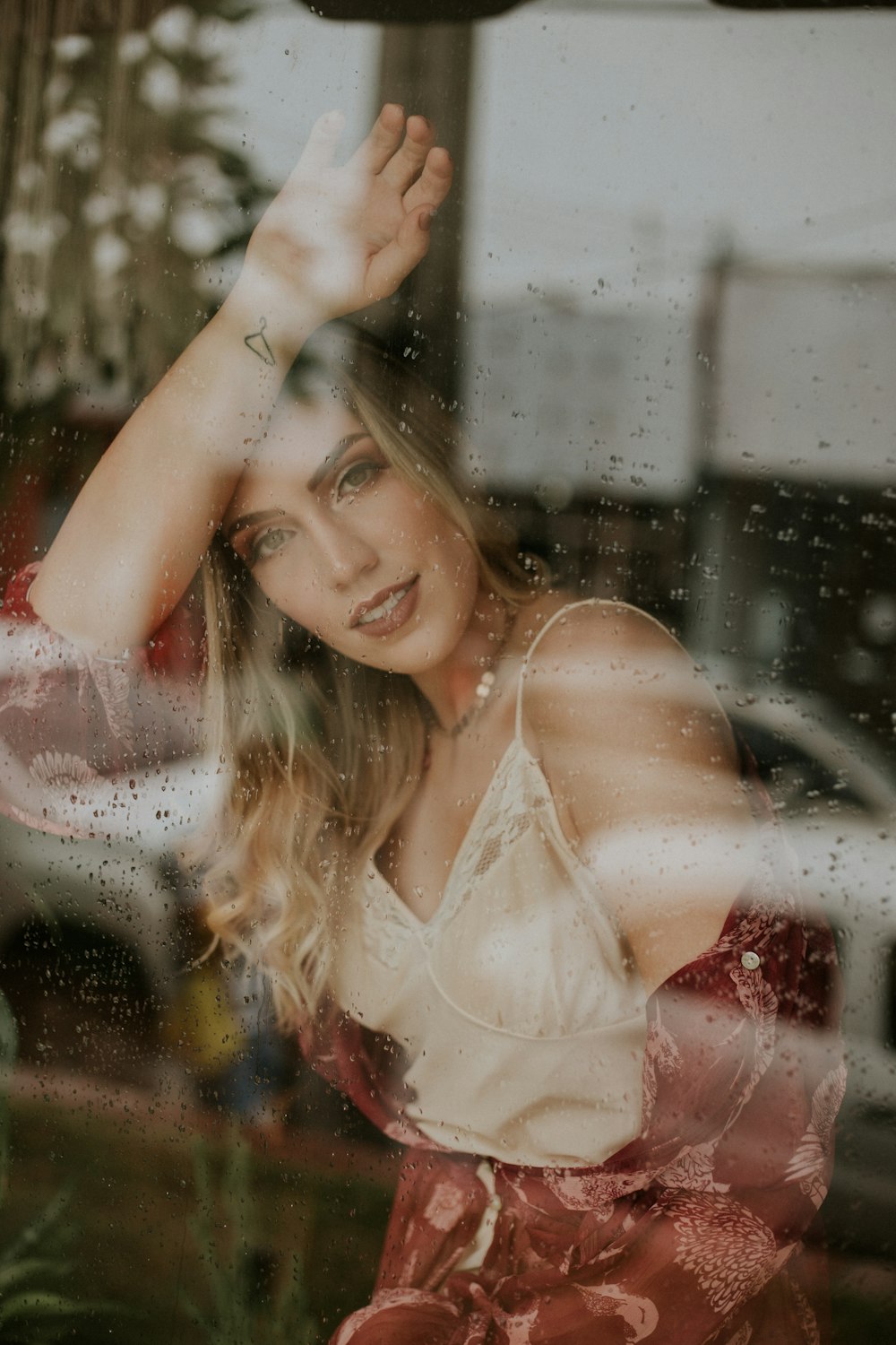 woman leaning on glass wall