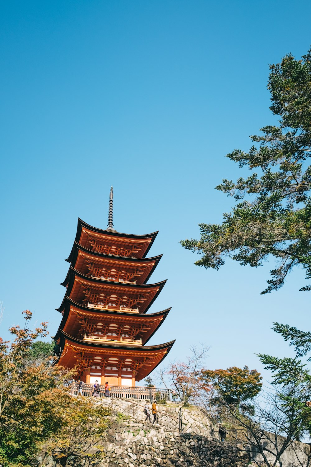 a tall pagoda sitting on top of a hill