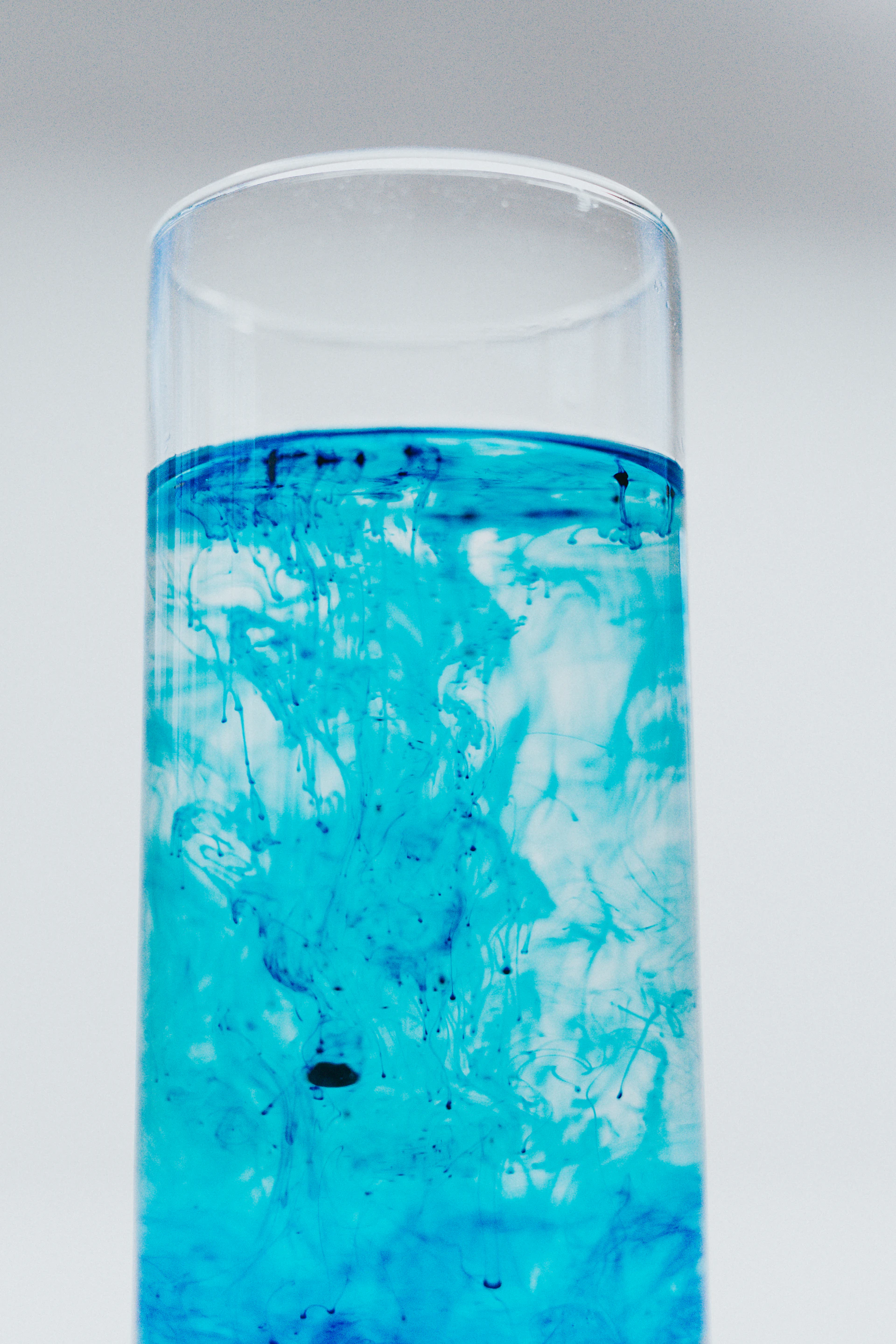 A vibrant gel tube squeezed onto a hand, showing its cooling effect with a subtle blue tint, set against a calming background of light blues and whites.