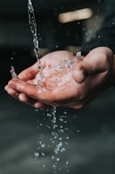 clear liquid pouring on person's hands