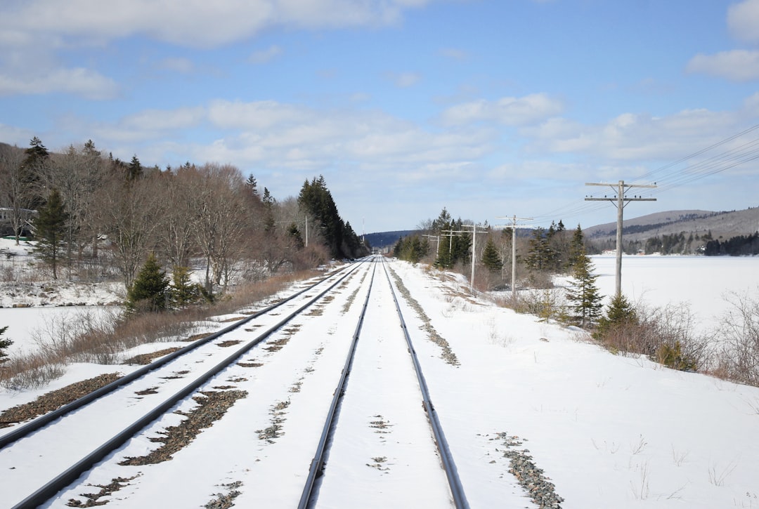 railway covered with snow under cloudy sky