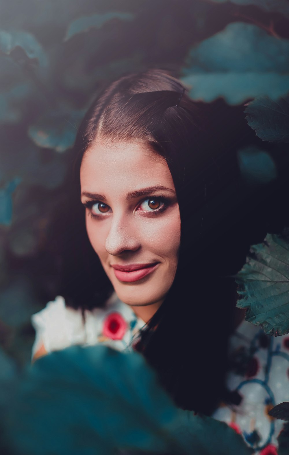 woman in white, red, and green floral shirt