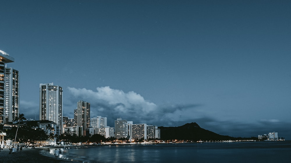 white high-rise building near calm sea water