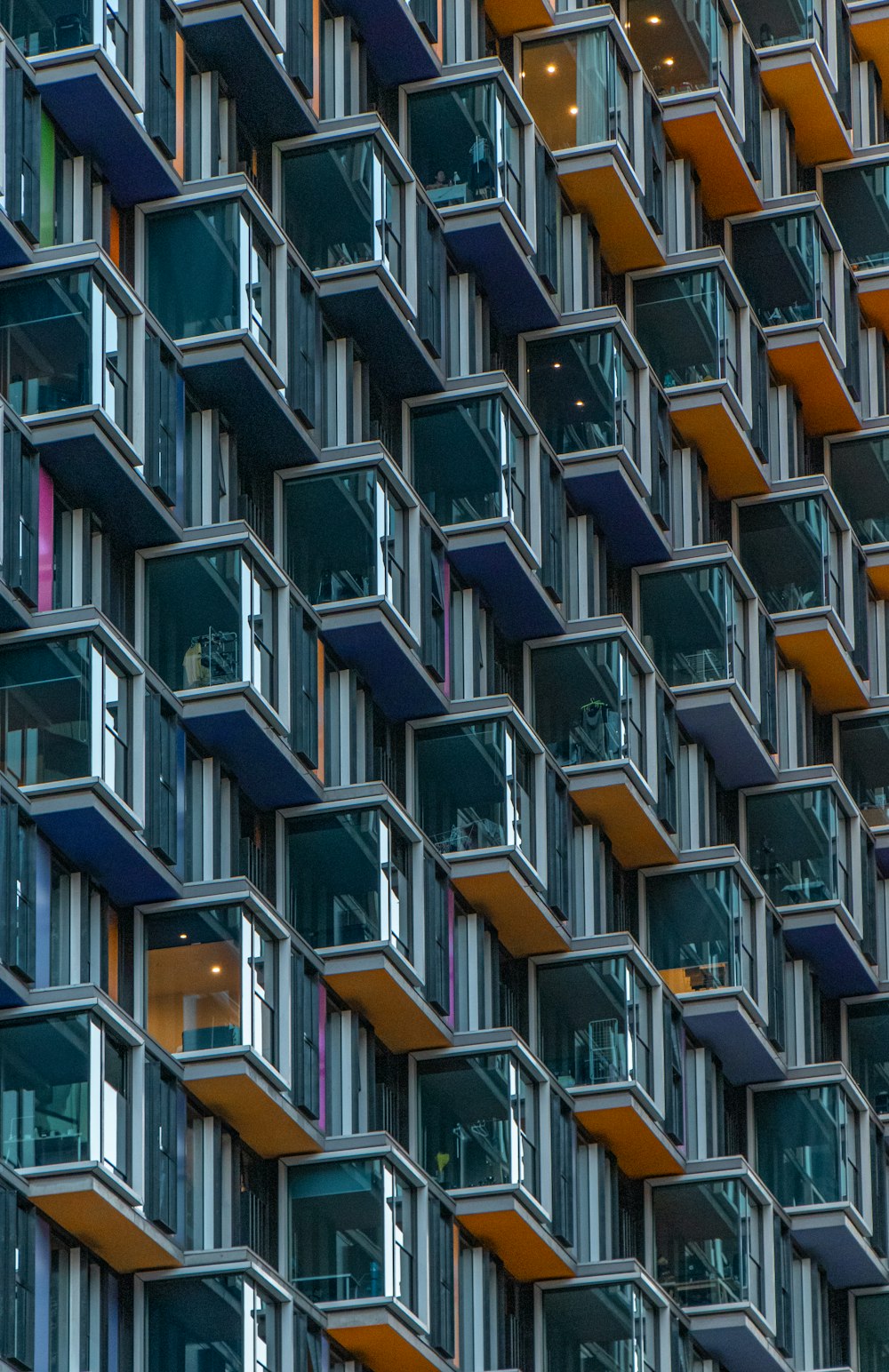 low-angle photo of orange and blue high-rise building