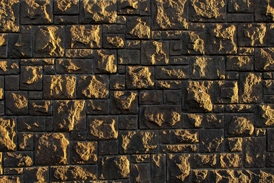 A freshly renovated stone wall showcasing expert masonry work under natural daylight.