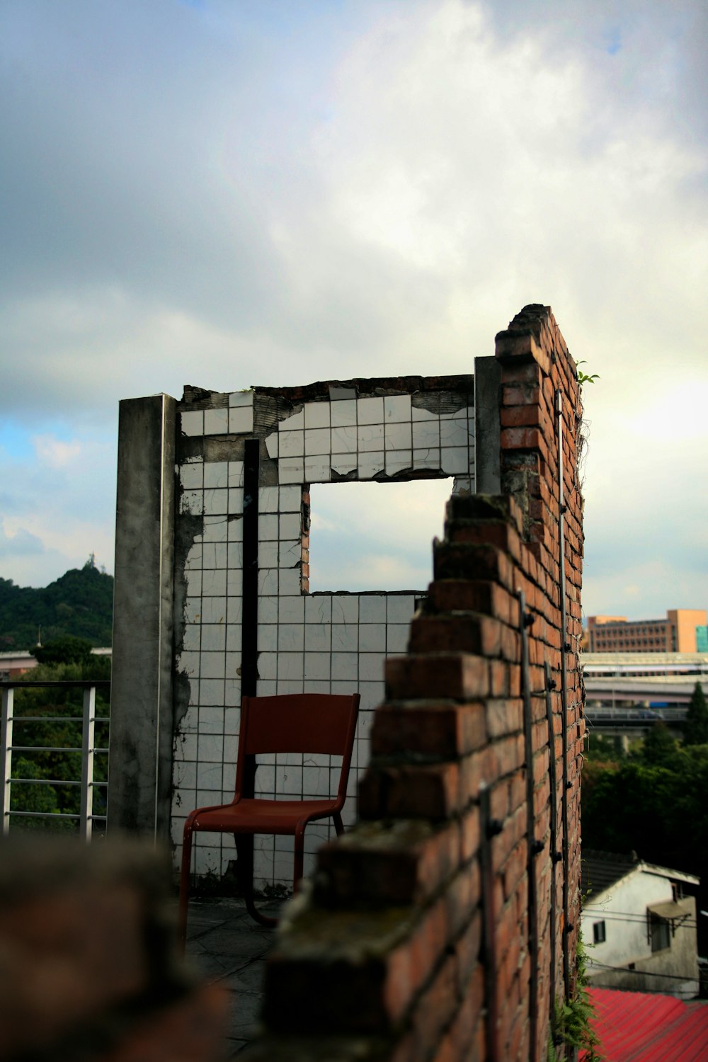 red metal chair beside wall