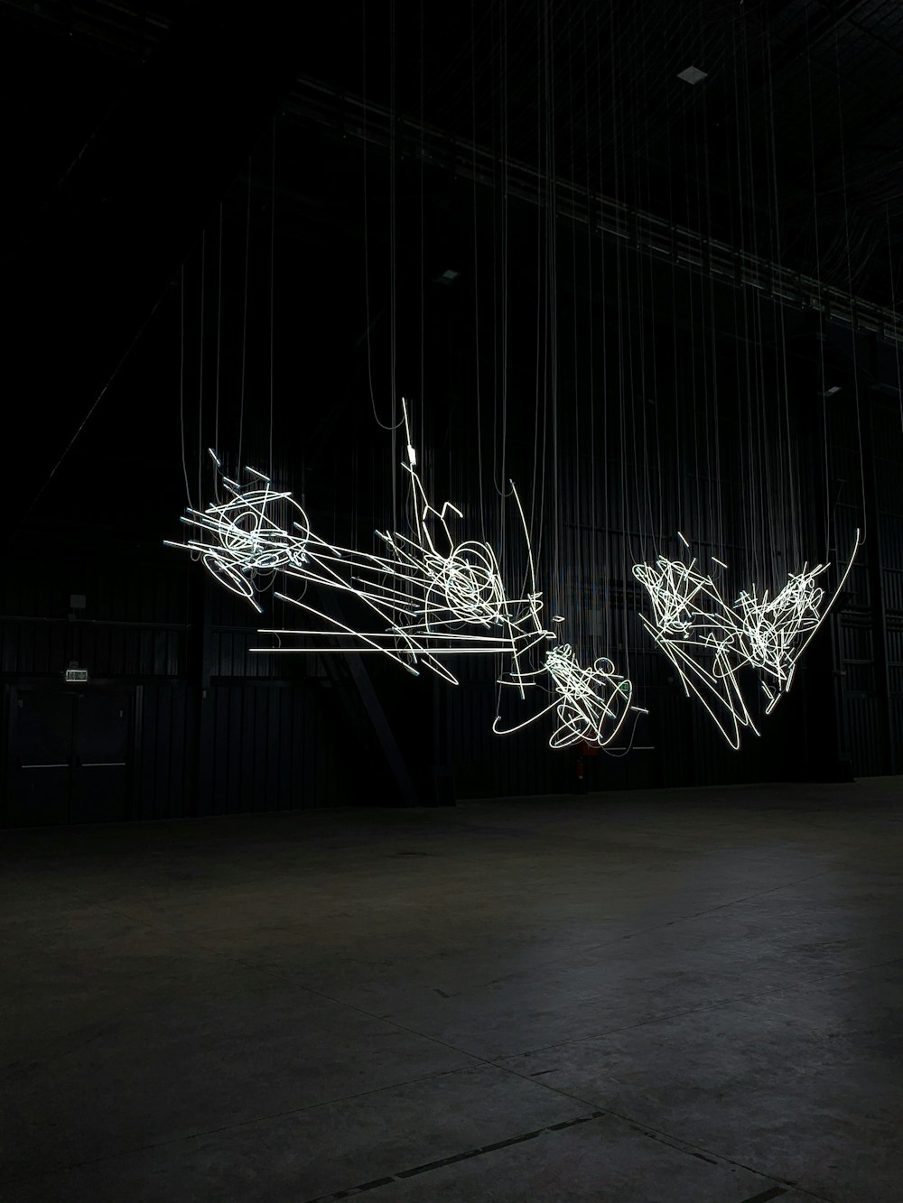 a black room with a string of lights hanging from the ceiling