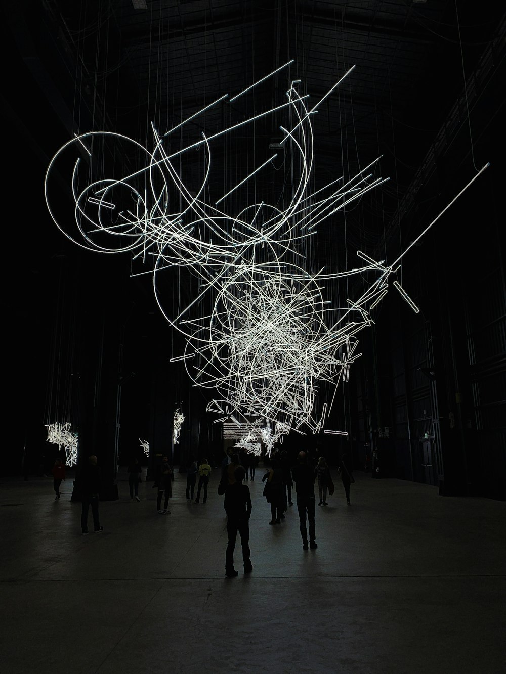 a group of people standing in a dark room