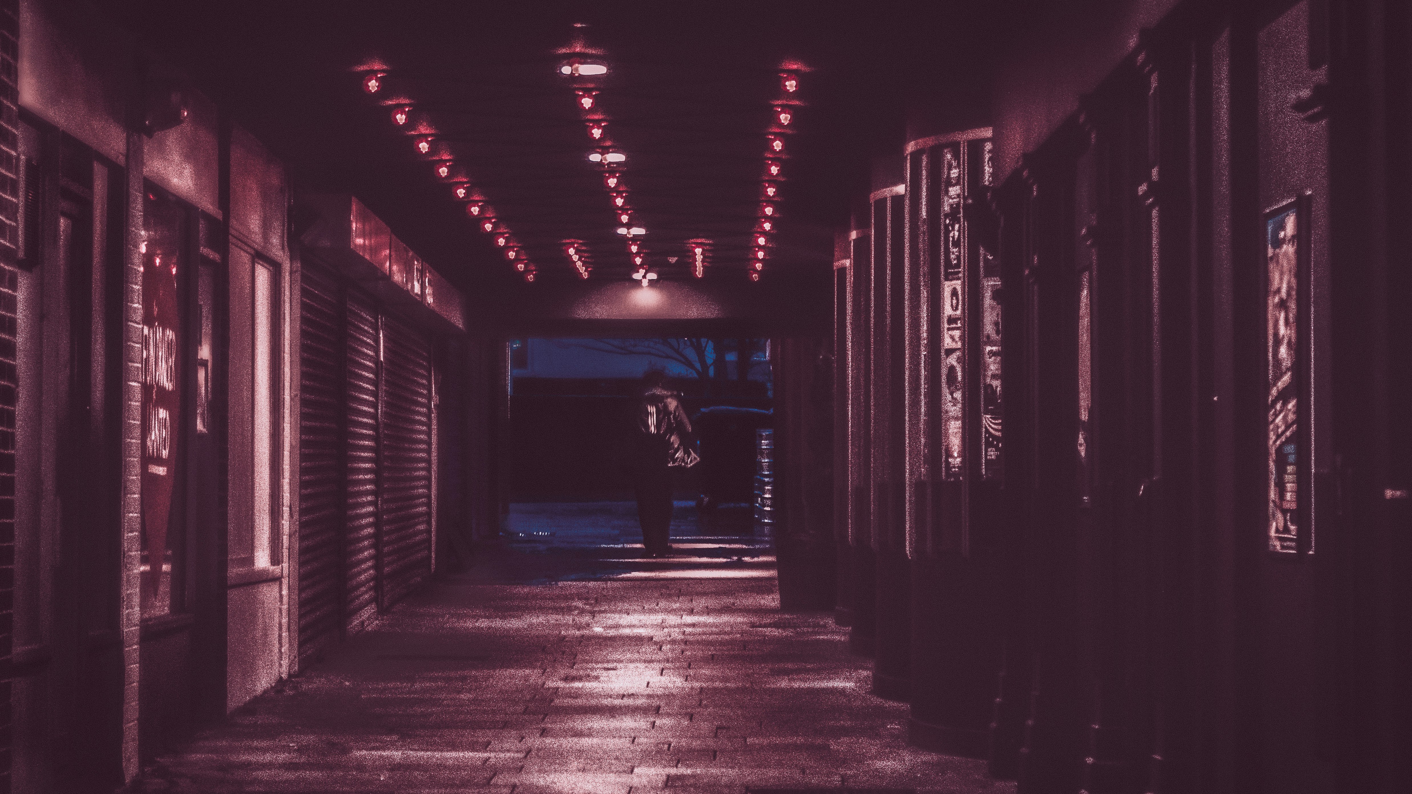 Person walking through a red-lit entry.