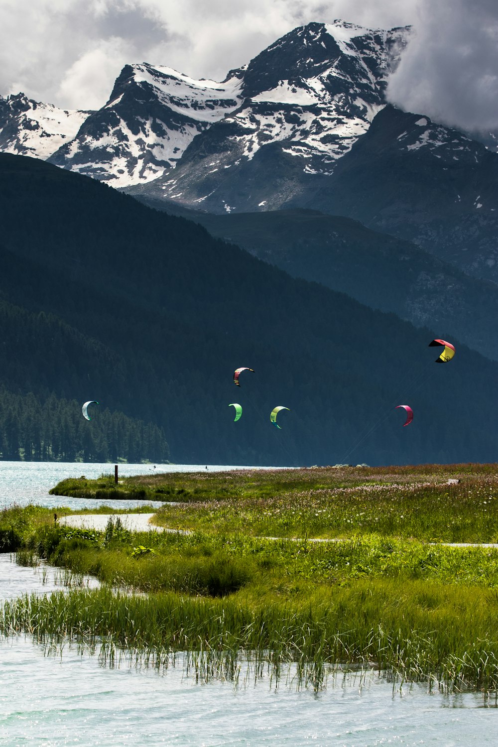group of people paragliding beside river