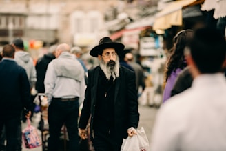 man wearing black coat and hat