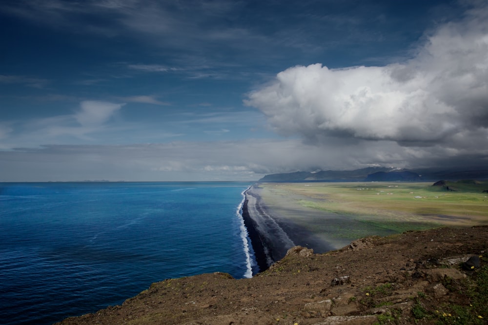 a large body of water sitting on the side of a cliff