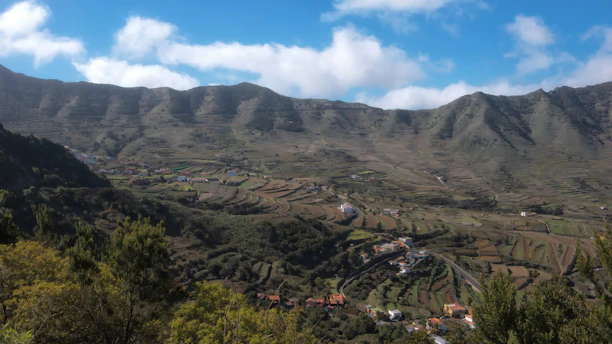 A breathtaking view of Hunza Valley's terraced fields under a clear blue sky.
