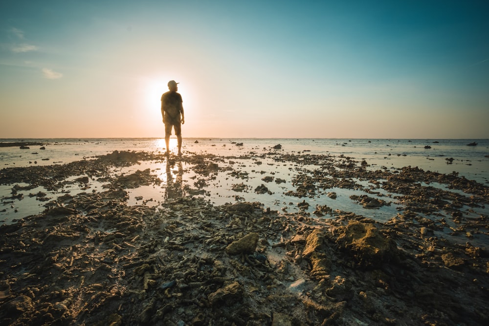 man standing near body of water