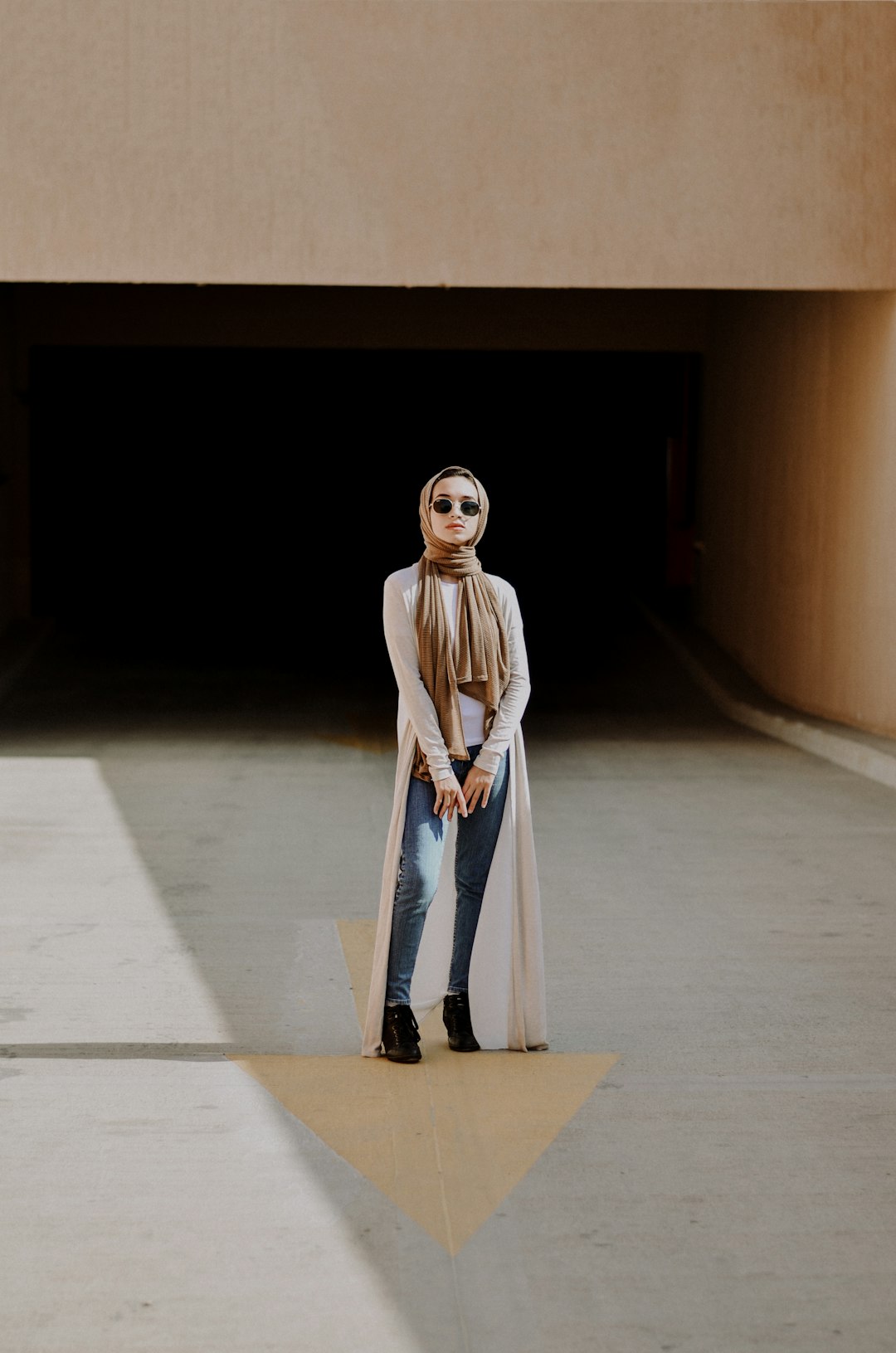 woman wearing white long-sleeved shirt and blue denim jeans