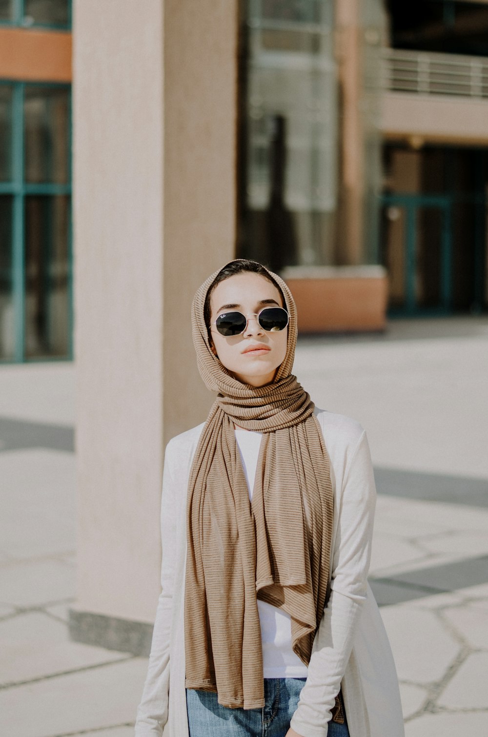 woman wearing white long-sleeved shirt and brown scarf