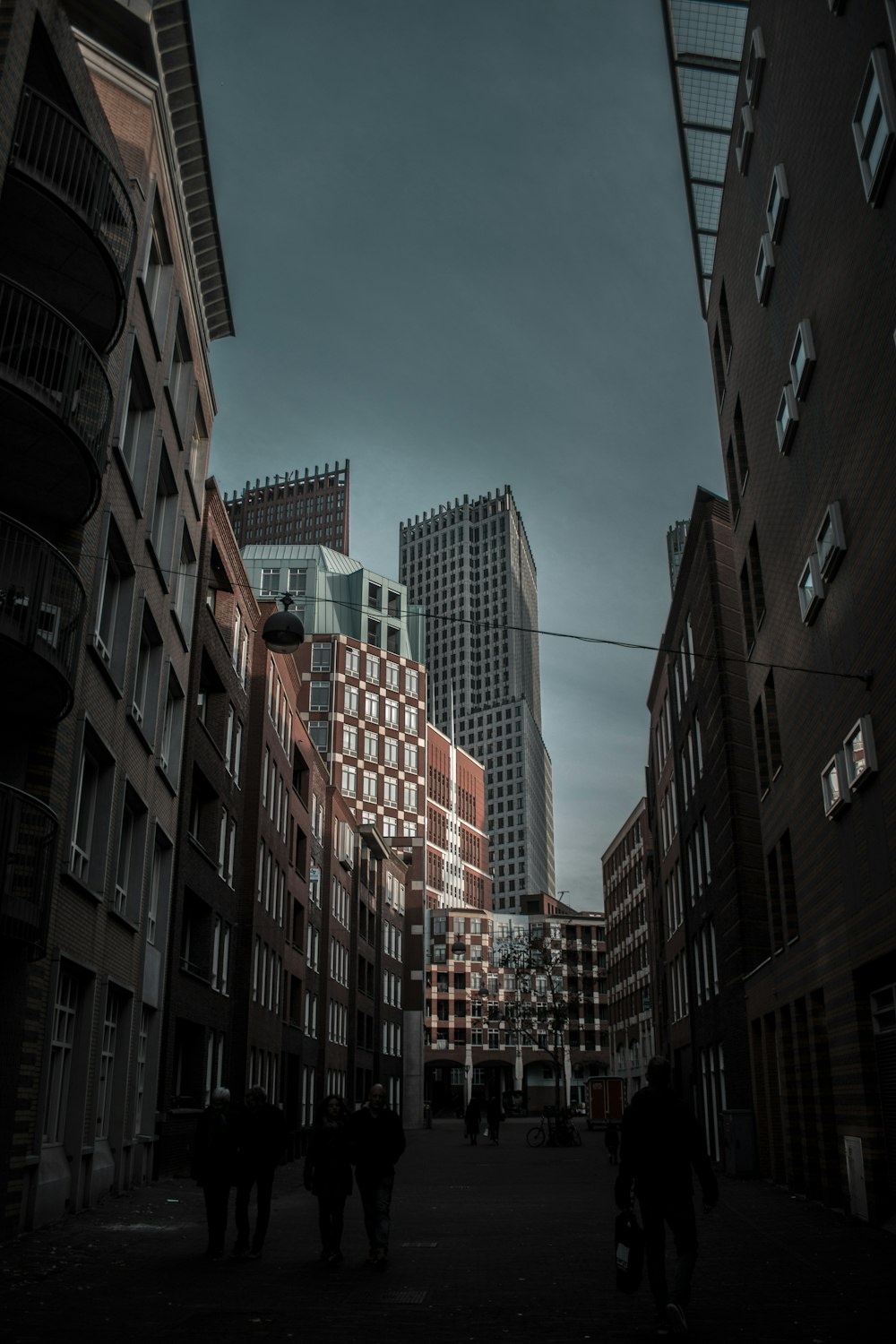 people walking on street between buildings