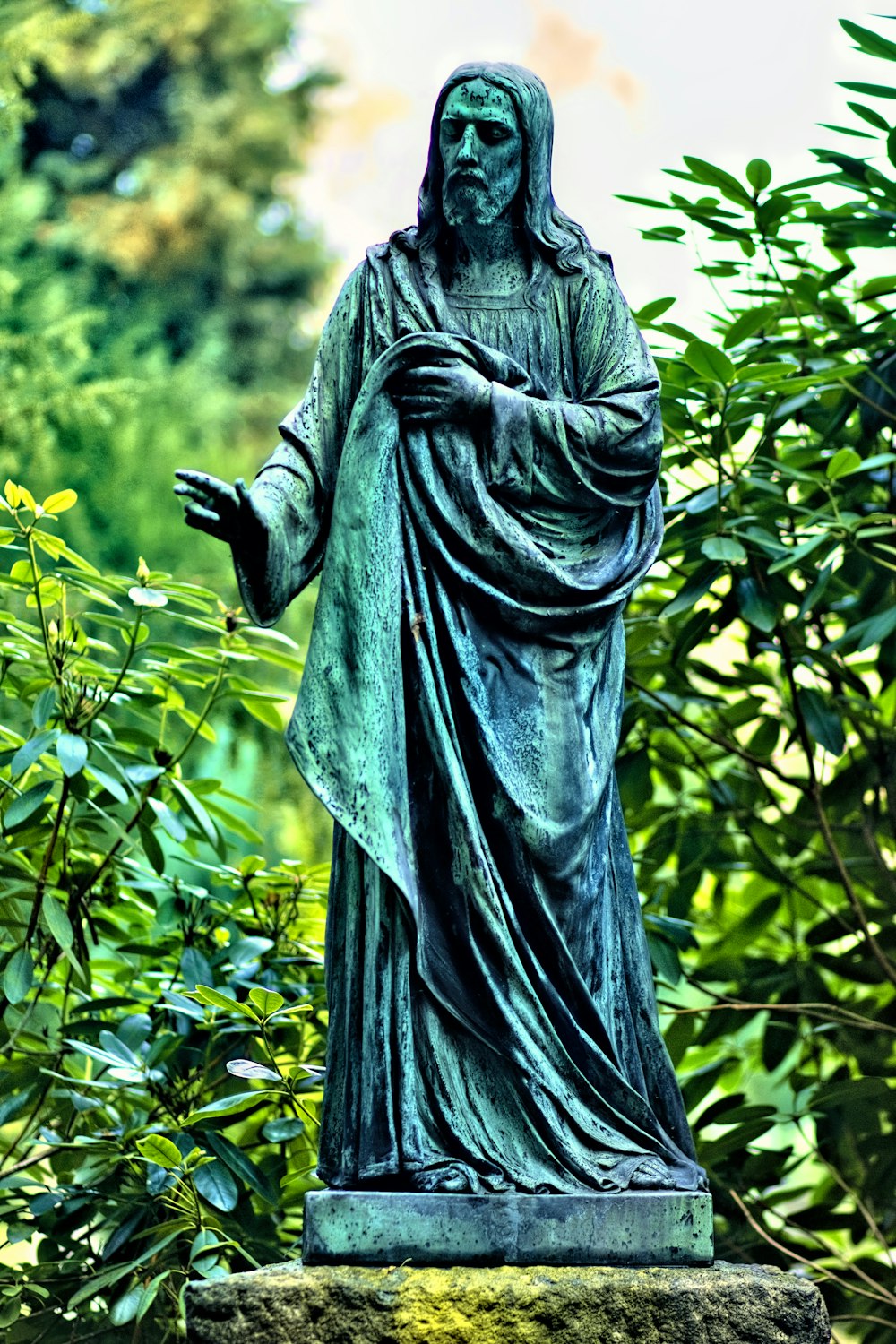 Jesus Christ statue beside plants