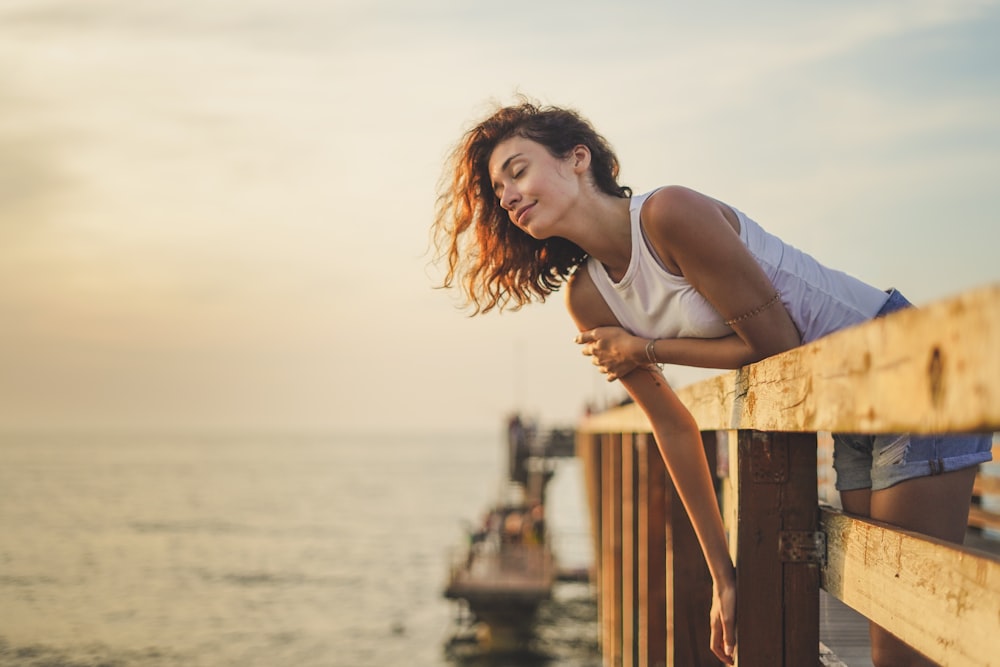 woman leaning forward on dock rail