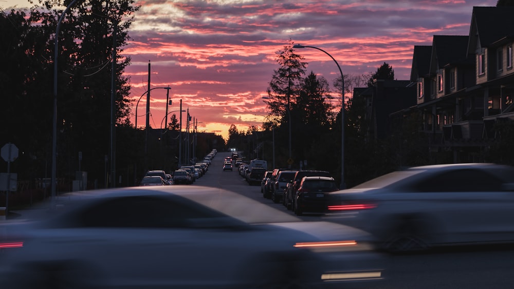 vehicles crossing on road during sunset