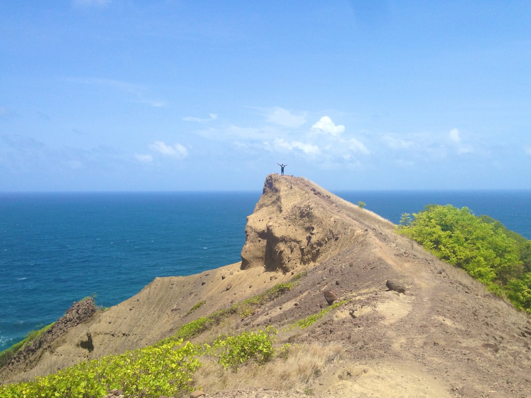 man standing on rock edge,