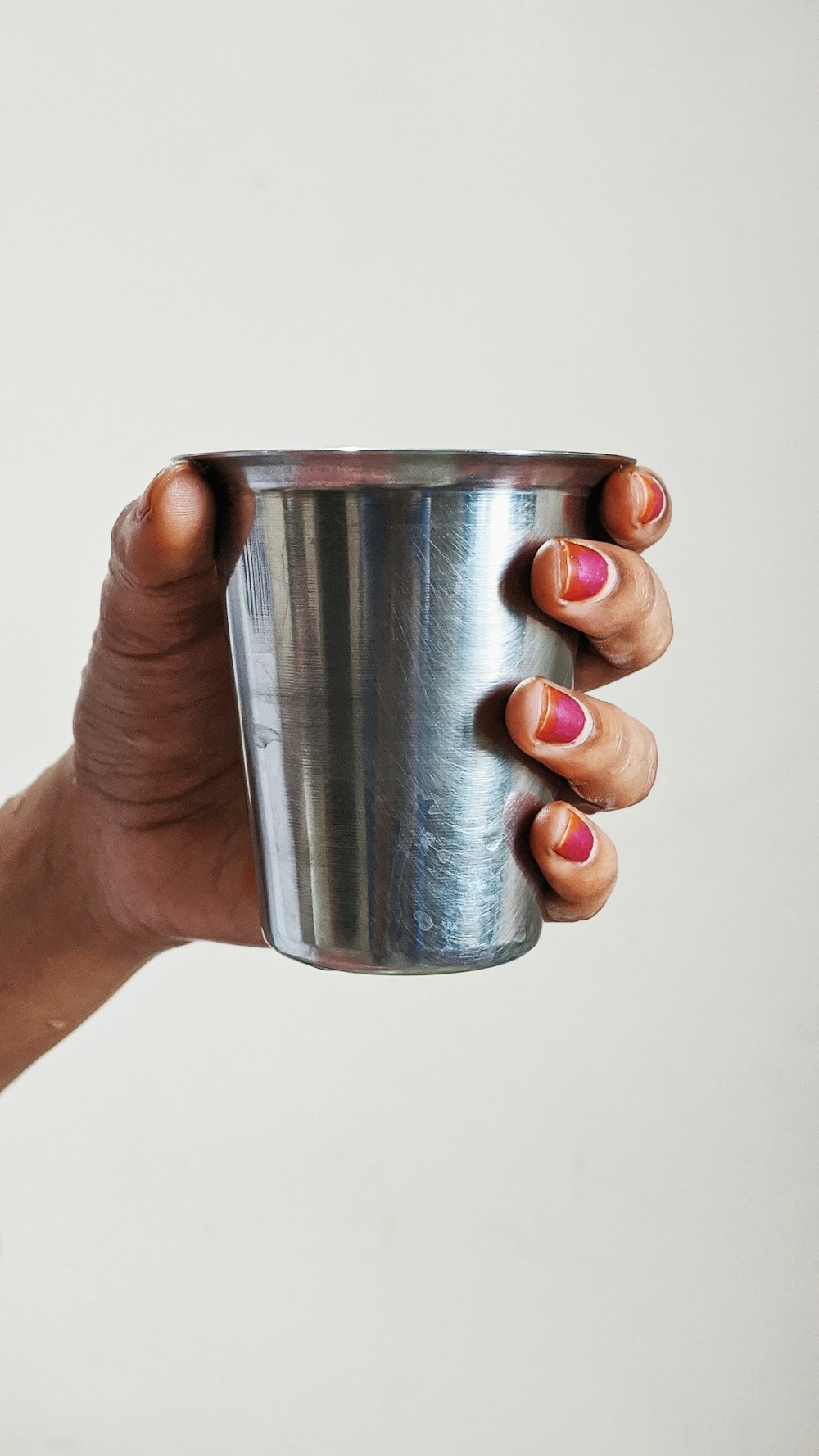 person holding silver cup