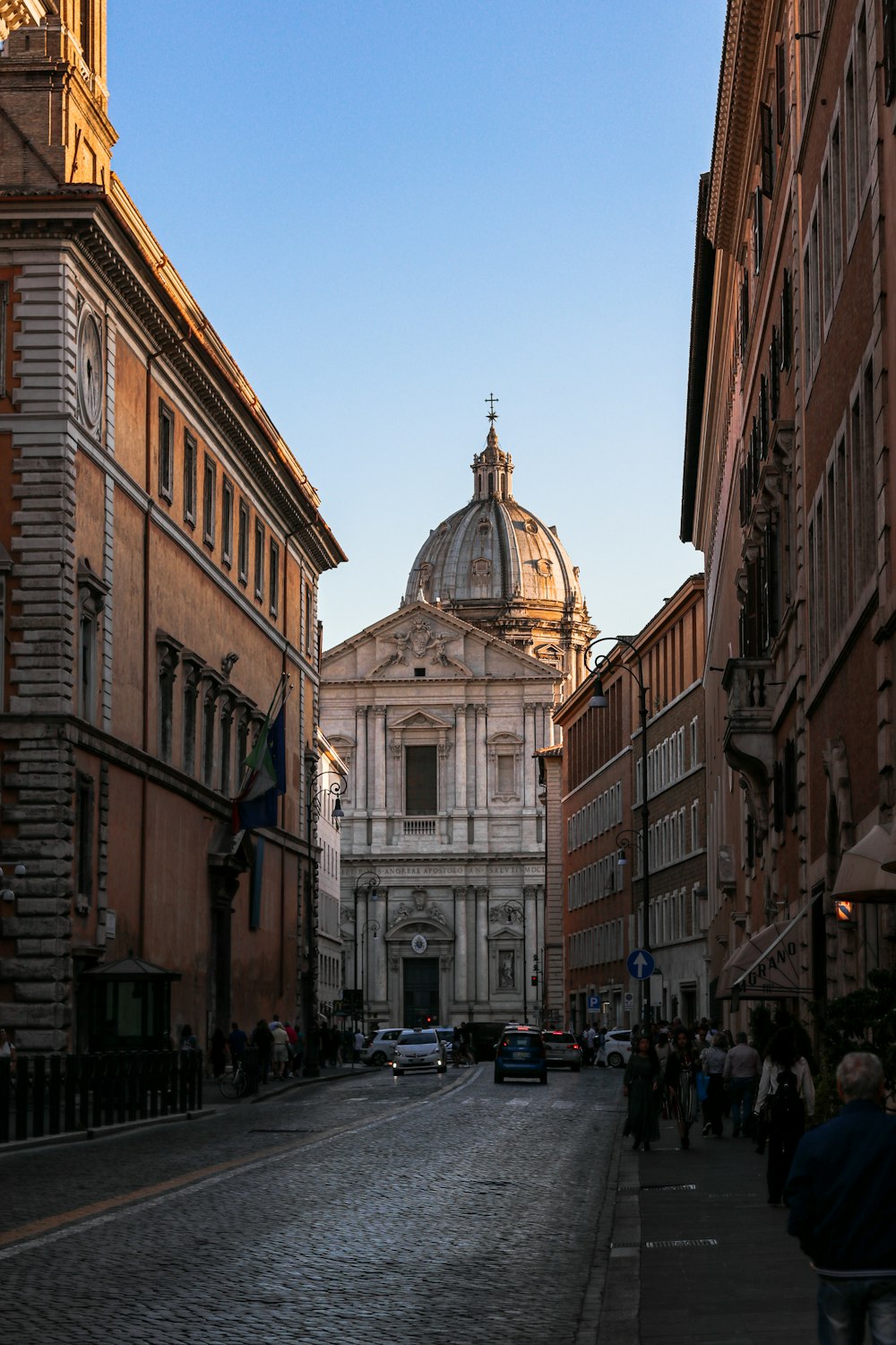 a cobblestone street with a church in the background