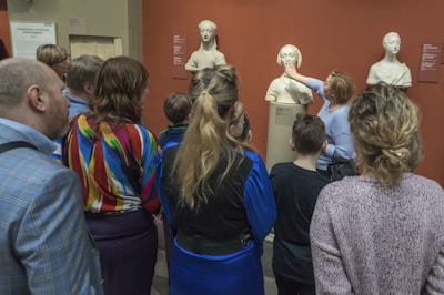 A museum educator guiding a small group through an interactive exhibit in Bucharest.