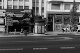 a black and white photo of a street corner