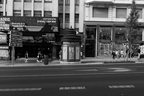 a black and white photo of a street corner