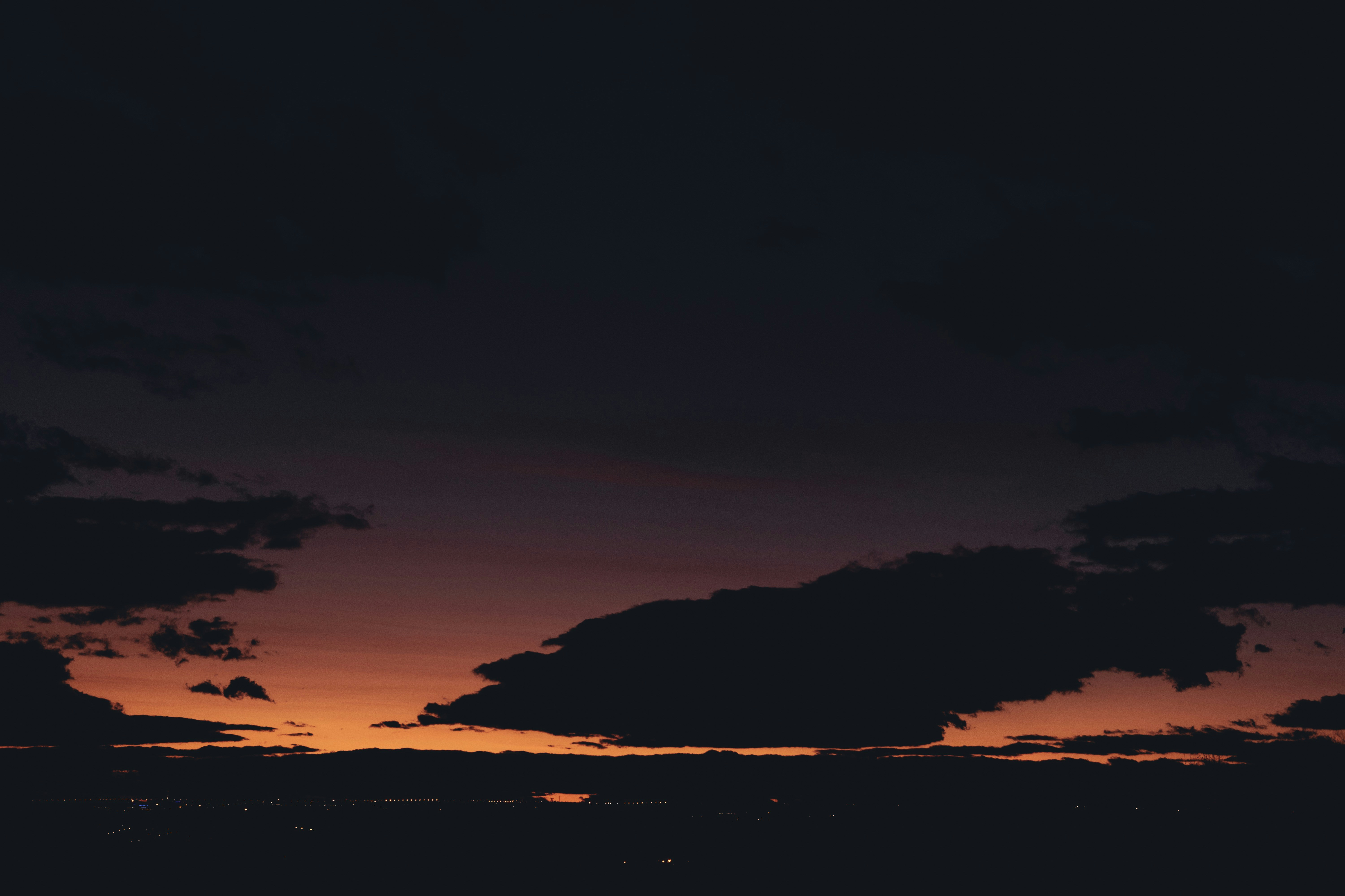 a plane is flying in the sky at sunset