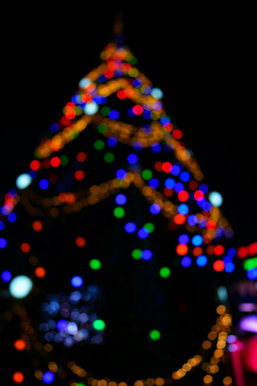 selective focus photo of Christmas tree with turned-on string lights