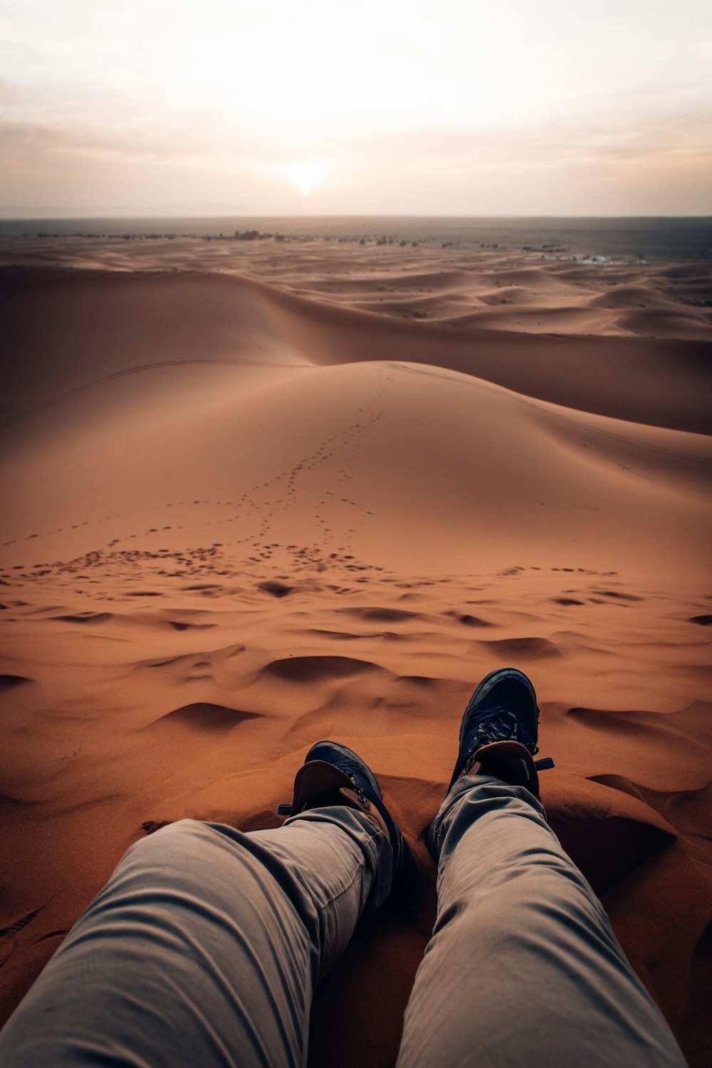 person sitting on sand