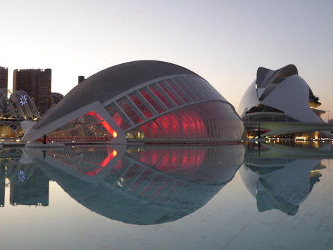 Architectural model of a futuristic entertainment complex glowing at dusk.