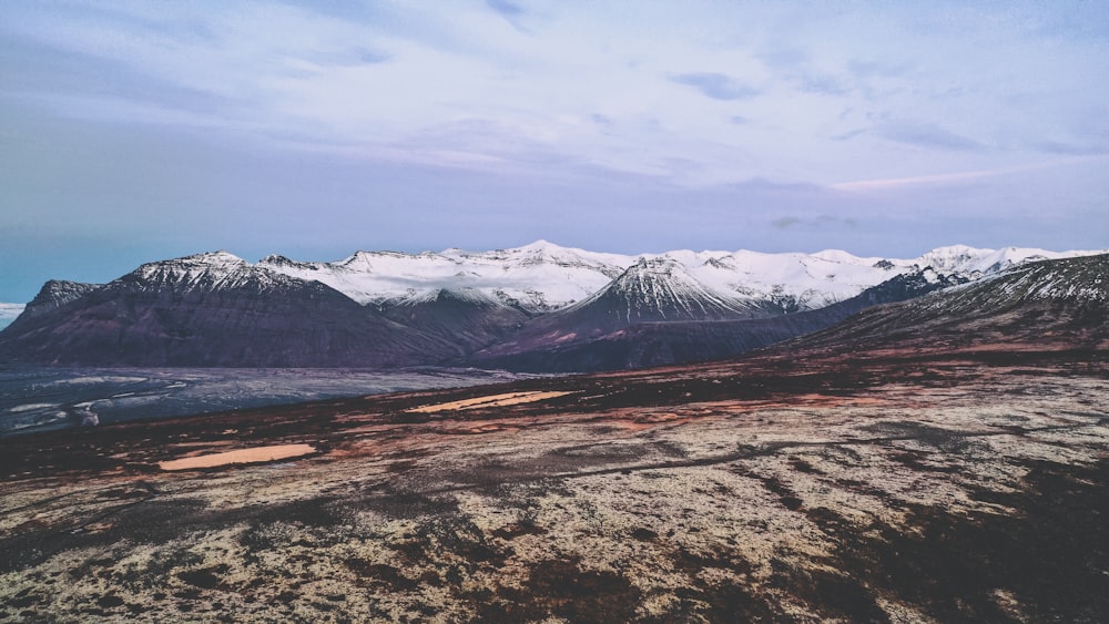 snow covered mountain under cloudy sky