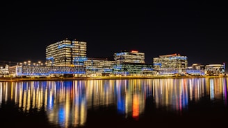 a city at night reflected in the water