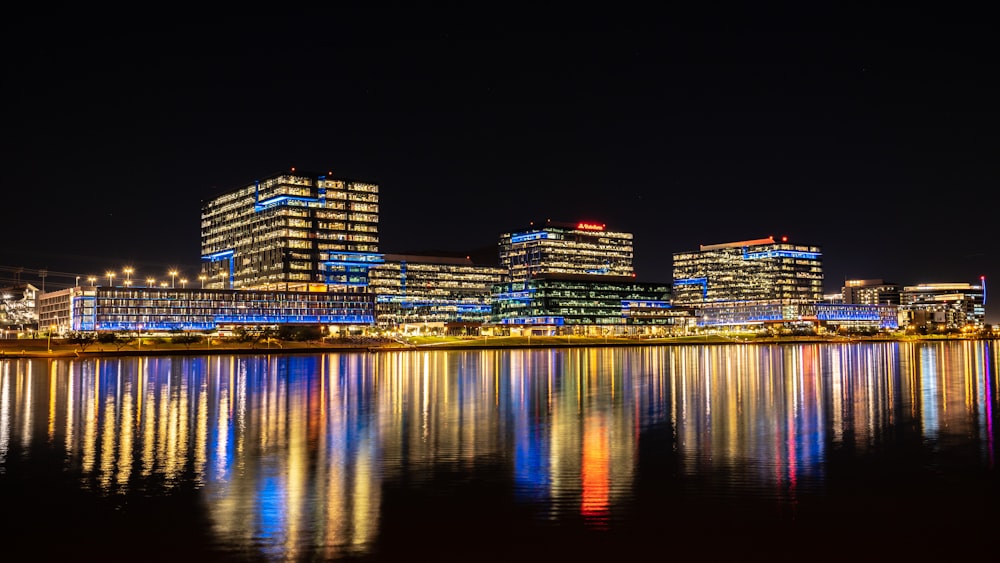 a city at night reflected in the water