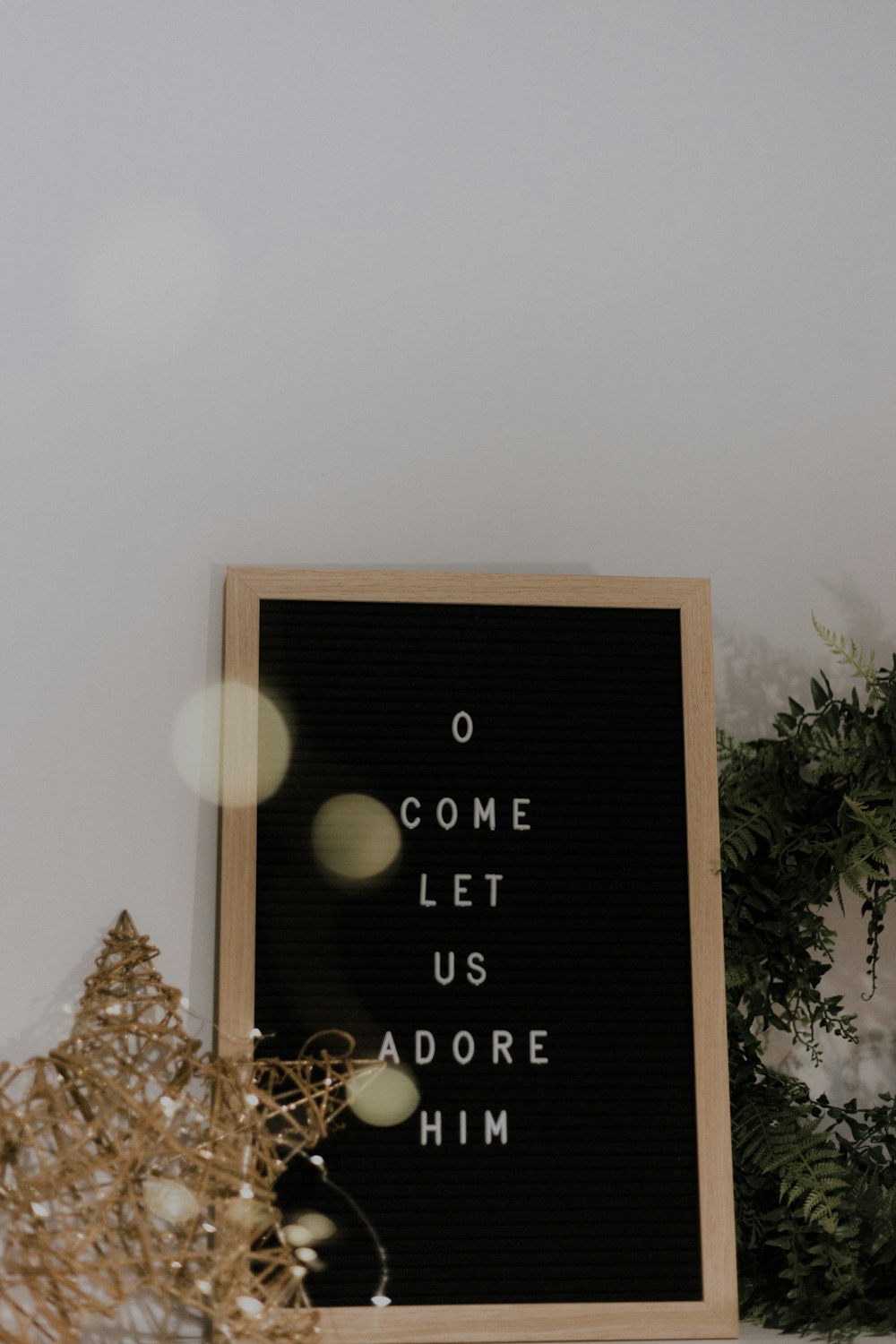 brown photo frame beside wall